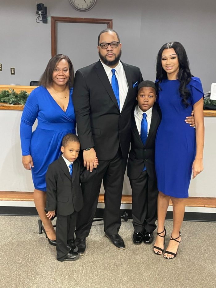 Mrs. Harper and her family smiling for the camera