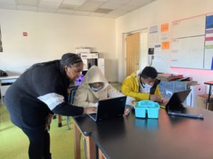 Ms. Brinkley assisting her students with classwork