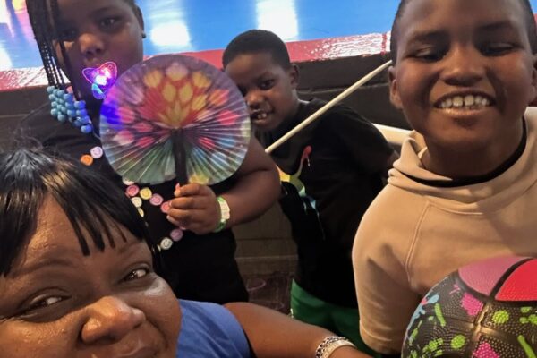 KIPP DC parent, Ms. Erica Henry and her children smiling at camera