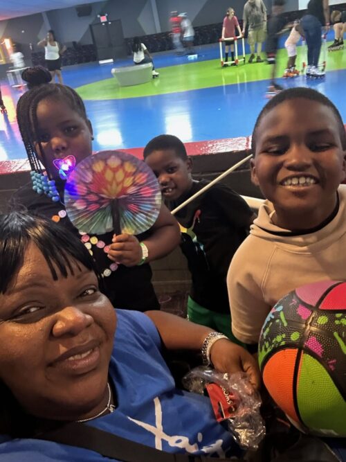 KIPP DC parent, Ms. Erica Henry and her children smiling at camera