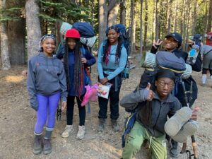Students smiling in the woods