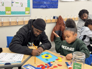 A parent and student solving a math problem together