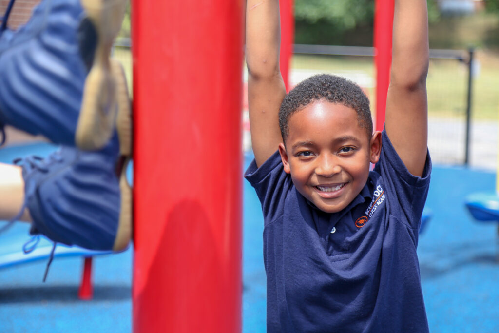Quest Academy student smiling and enjoying playground activities